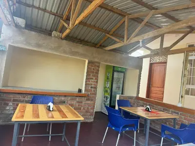 a room with two tables and chairs and a projection screen at Seven Seven B&B in Arusha