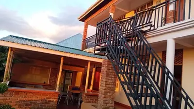 a house with a metal staircase in front of it at Seven Seven B&B in Arusha