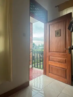 an open door with a view of a balcony at Seven Seven B&B in Arusha