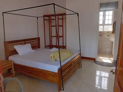 a bedroom with a canopy bed in a room at Seven Seven B&B in Arusha