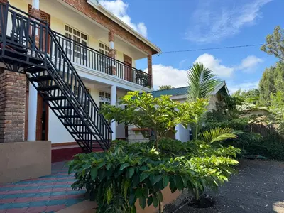 a house with a staircase and plants in front of it at Seven Seven B&B in Arusha