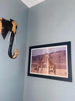 a picture of two giraffes on a wall at KILIMANJARO HOME OF RASON in Msaranga