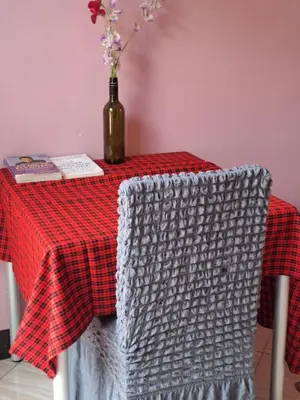 a table with a red and white checkered table cloth at KILIMANJARO HOME OF RASON in Msaranga