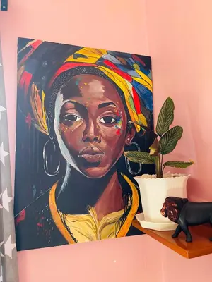 a painting of a woman on a wall at KILIMANJARO HOME OF RASON in Msaranga