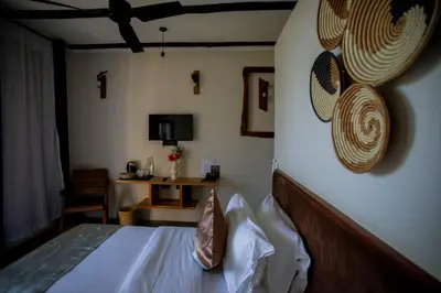 a bedroom with a bed with hats on the wall at The Maridadi Hotel in Moshi