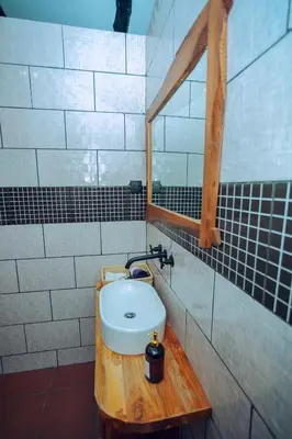 a bathroom with a toilet on a wooden table at The Maridadi Hotel in Moshi