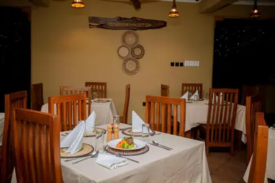 a dining room with a table with a plate of food at The Maridadi Hotel in Moshi