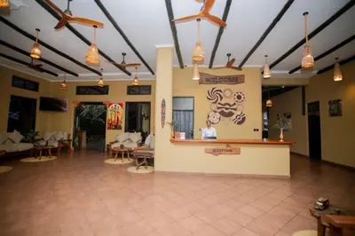 a lobby of a restaurant with a counter and chairs at The Maridadi Hotel in Moshi
