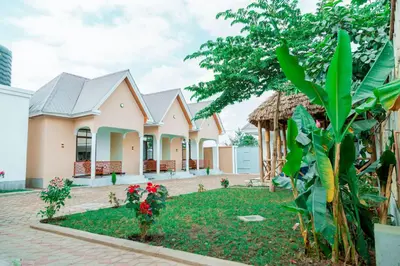 a house with a garden in front of it at Safi House in Boma la Ngombe