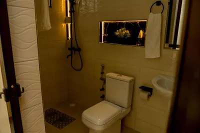 a small bathroom with a toilet and a sink at Safi House in Boma la Ngombe
