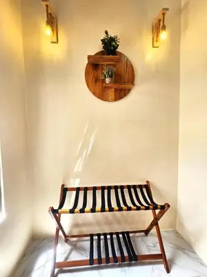 a bench in a room with a shelf on the wall at Safi House in Boma la Ngombe