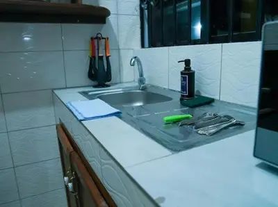 a kitchen counter with a sink and a bottle on it at ILBORU HAVEN HOMEs in Arusha