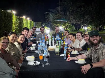a group of people sitting around a table with wine bottles at The New Njiro Legacy in Arusha