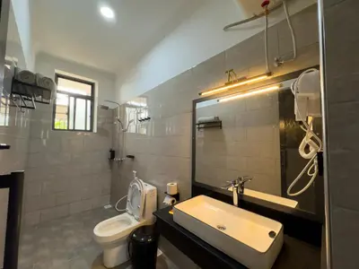 a bathroom with a sink and a toilet at The New Njiro Legacy in Arusha