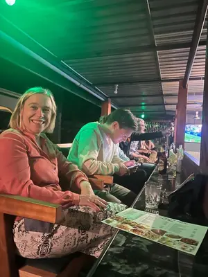 a man and a woman sitting at a bar at Kilimanjaro Trekcity Hostel in Moshi