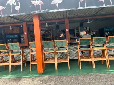 a group of chairs sitting in front of a bar at Kilimanjaro Trekcity Hostel in Moshi