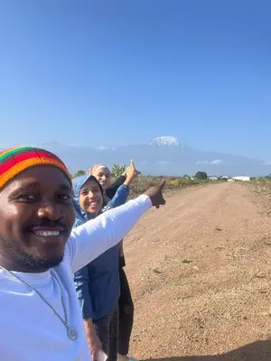 a group of people standing on a dirt road at Kilimanjaro Trekcity Hostel in Moshi