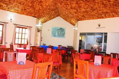 a restaurant with red and blue tables and chairs at Destination 3Degrees Hotel in Arusha