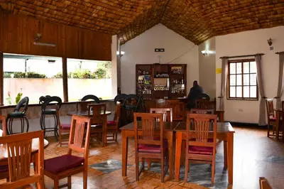 a dining room with wooden tables and chairs at Destination 3Degrees Hotel in Arusha