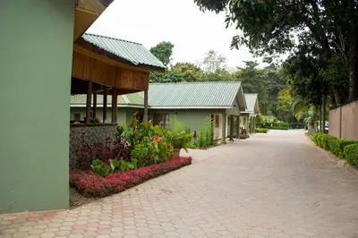 a brick road next to a building with flowers at Destination 3Degrees Hotel in Arusha