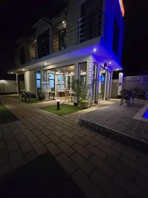 a building with a blue light on it at night at Primeland Hotel in Moshi