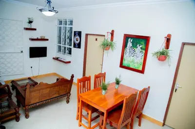 a dining room with a wooden table and chairs at B&B HOTEL in Moshi