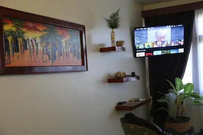 a flat screen tv hanging on a wall in a room at B&B HOTEL in Moshi