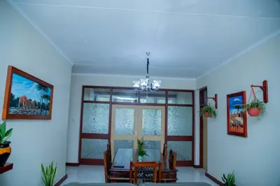 a dining room with a table and a window at B&B HOTEL in Moshi