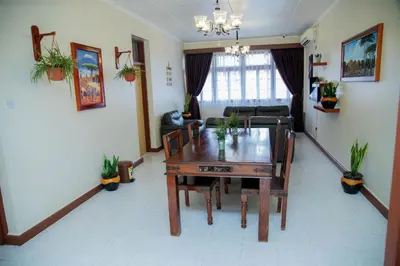 a living room with a table and a couch at B&B HOTEL in Moshi