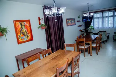 a dining room with wooden tables and chairs at B&B HOTEL in Moshi