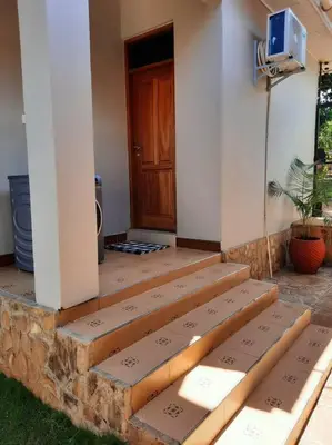 a set of steps to a house with a door at Ellyz Home Stay in Moshi