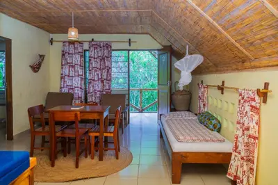 a dining room with a table and chairs at Meru Mbega Lodge in Usa River