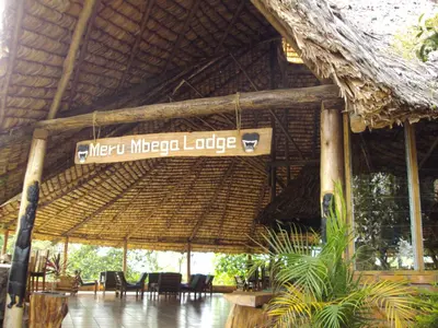 a restaurant with a sign that reads mxt microgae lodge at Meru Mbega Lodge in Usa River
