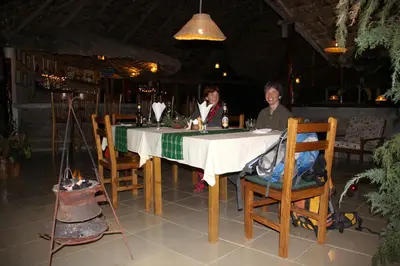 two people sitting at a table in a restaurant at Meru Mbega Lodge in Usa River