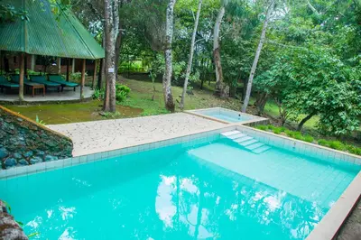 a swimming pool in the middle of a yard at Meru Mbega Lodge in Usa River