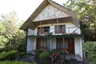 a house with ivy on the side of it at Meru Mbega Lodge in Usa River