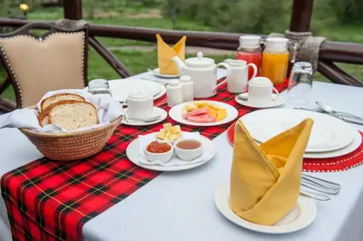 a table with a plate of breakfast food on it at Lake Ndutu Luxury Tented Lodge in Sinoni