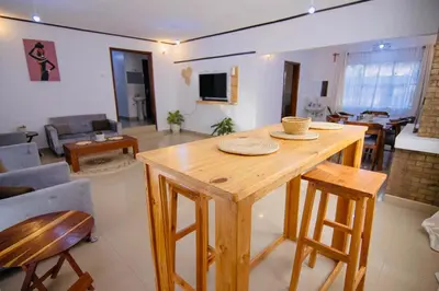 a living room with a wooden table and chairs at venem house in Kisongo