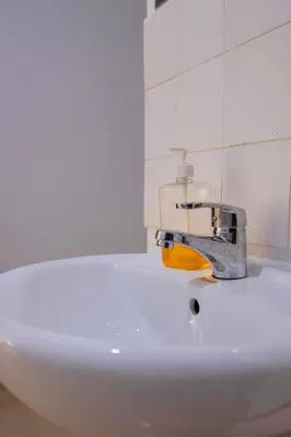 a bathroom sink with a faucet on top of it at venem house in Kisongo