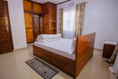 a bedroom with a bed in a room at venem house in Kisongo