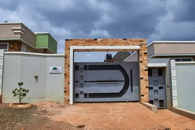 a large garage door in front of a house at Mvule Homes in Arusha