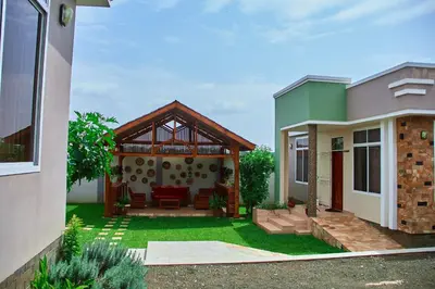a house with a patio and a house at Mvule Homes in Arusha