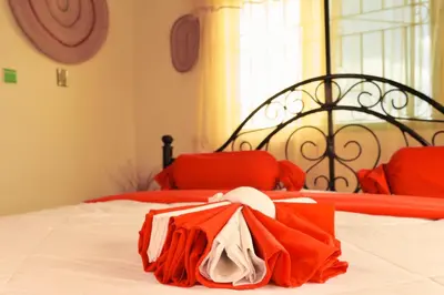 a red and white bed with a bag on it at Msovi Hideaway in Arusha