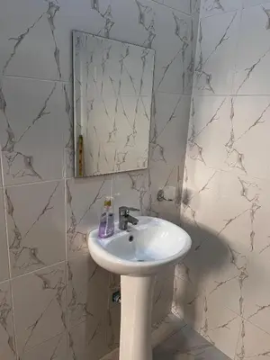 a bathroom with a sink and a mirror at Sinana Escapes - Arusha in Arusha