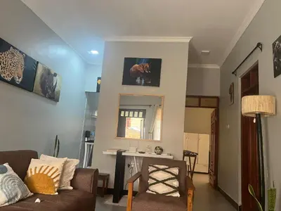 a living room with a couch and a table at Sinana Escapes - Arusha in Arusha