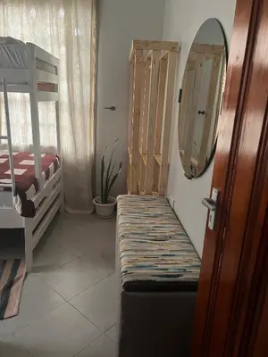 a bedroom with a bunk bed and a mirror at Sinana Escapes - Arusha in Arusha