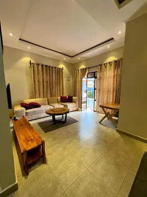 a living room with a couch and a table at Moshi Epic Accommodation in Moshi