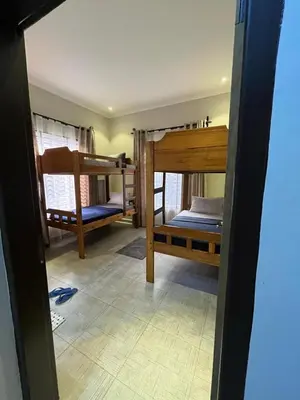 a room with two bunk beds in a house at Moshi Epic Accommodation in Moshi