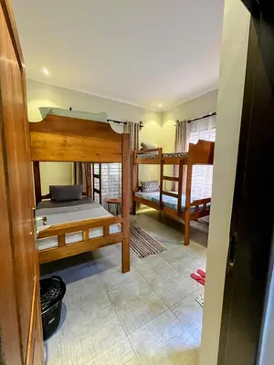 a room with three bunk beds in a room at Moshi Epic Accommodation in Moshi