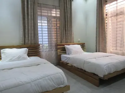 two beds sitting next to each other in a bedroom at Moshi Epic Accommodation in Moshi